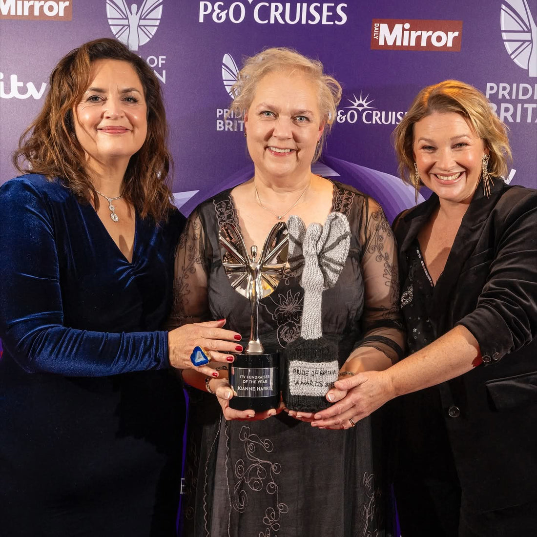 Pride of Britain winner 2025 Joanne Harris holding her knitted trophy designed by Wee Woolly Wonderfuls