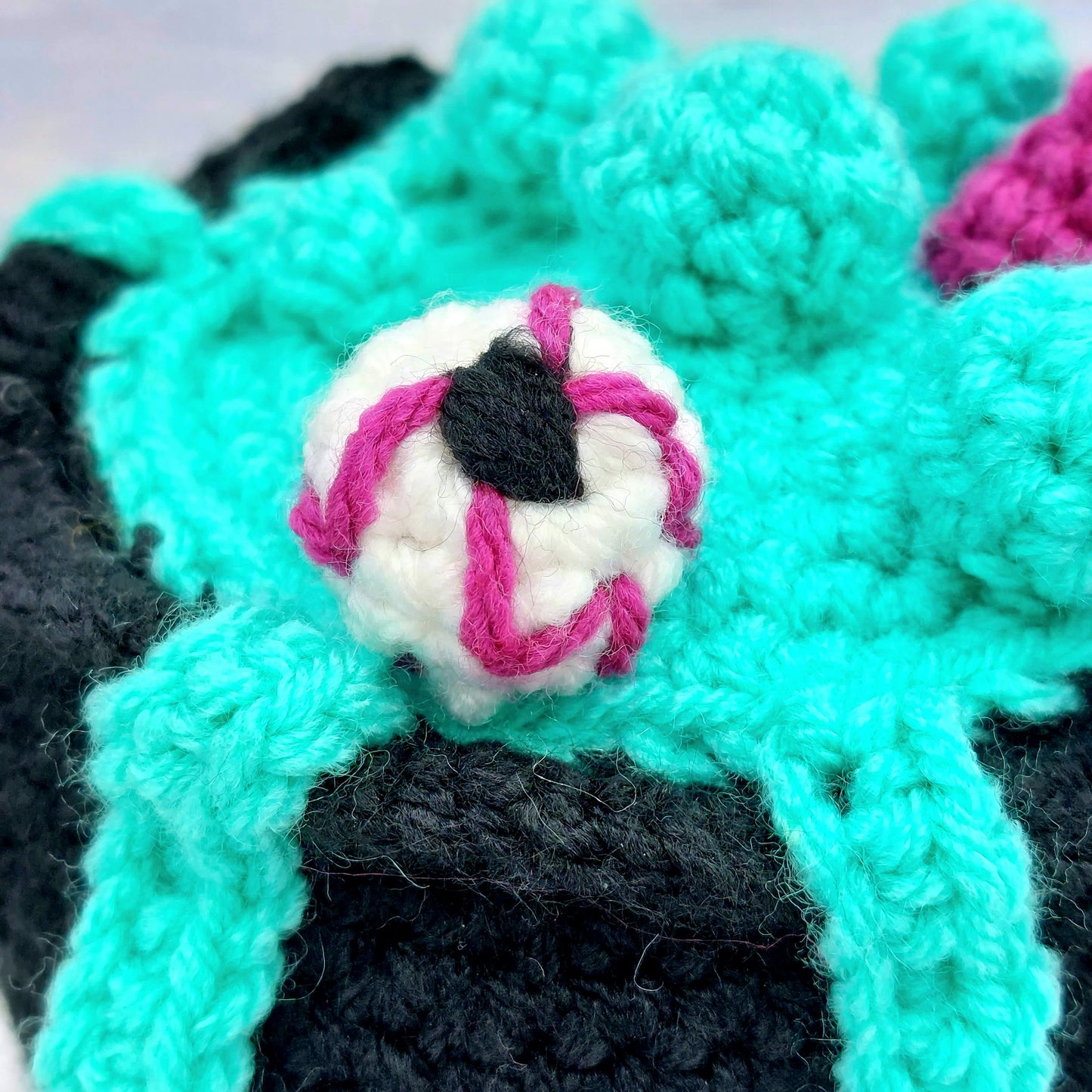 Close up of crochet spooky eye