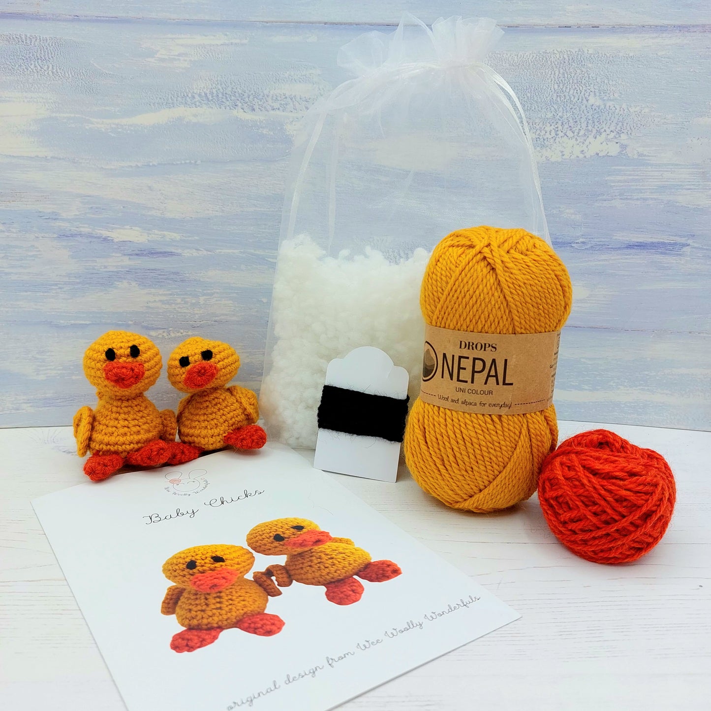Contents of Crochet Chicks Kit, including wool, pattern and stuffing