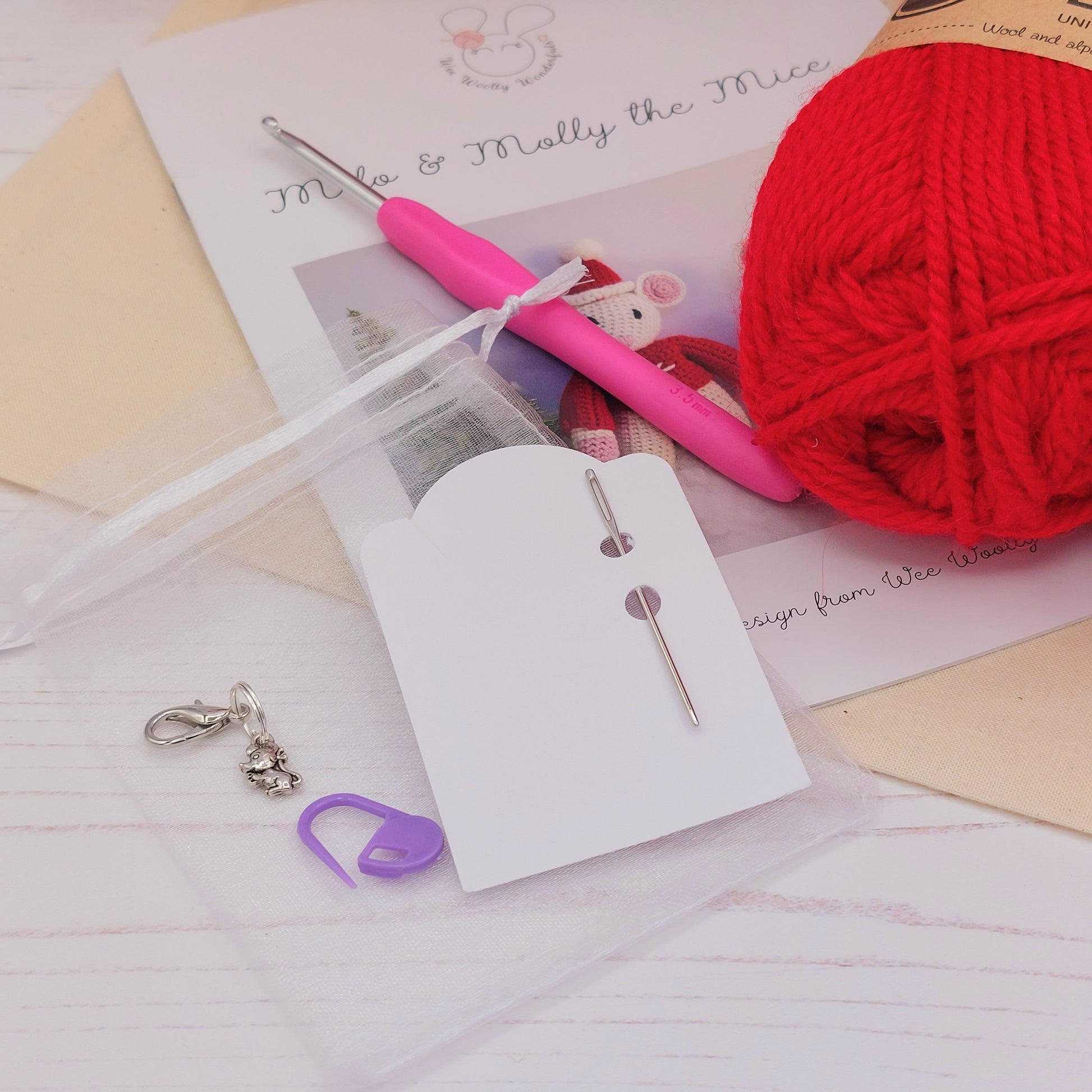 Close up of stitch markers and needle