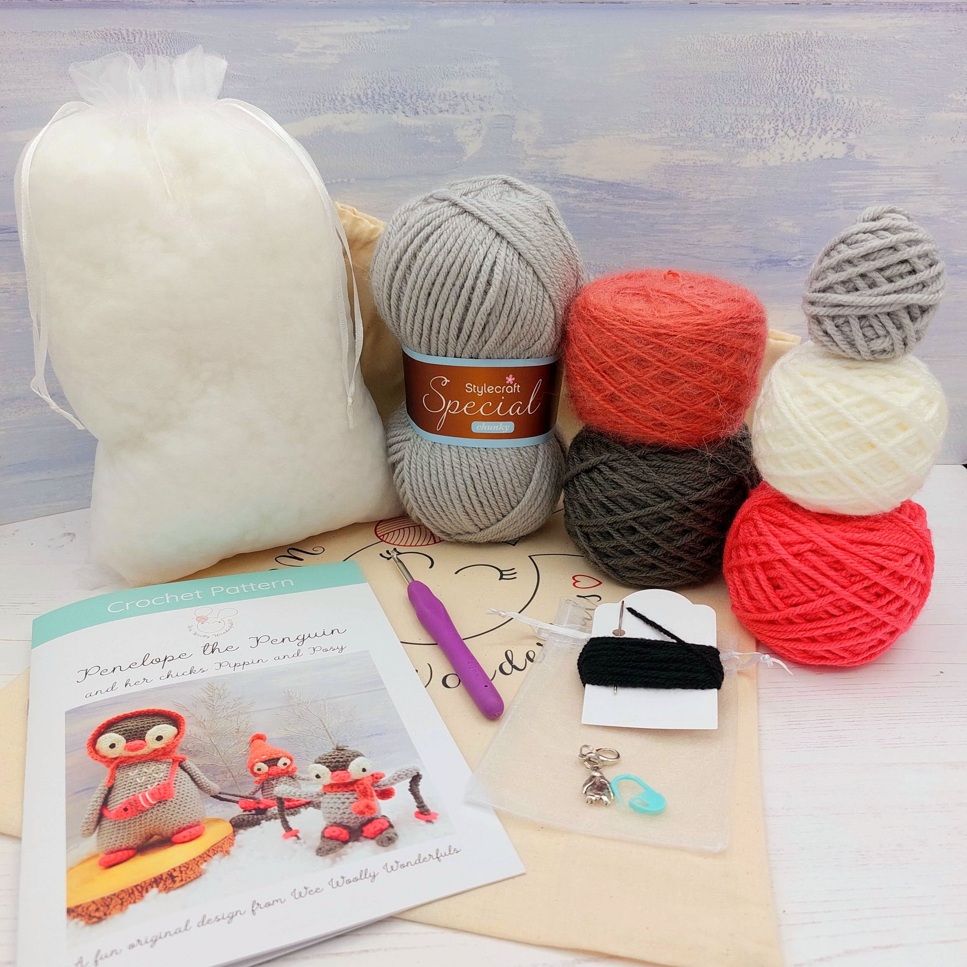Contents of Penguin Crochet KIt - wool, pattern, stuffing, project bag and stitch markers