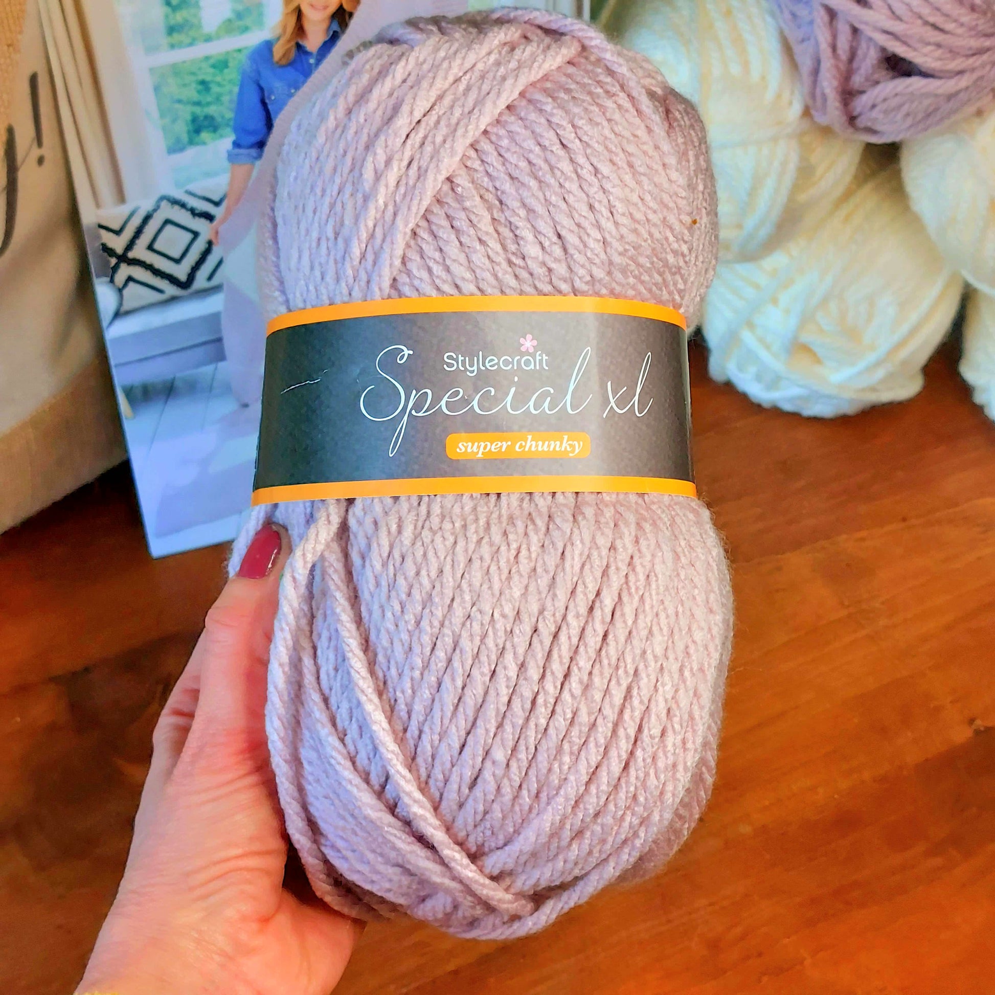 Lilac yarn held by woman's hand