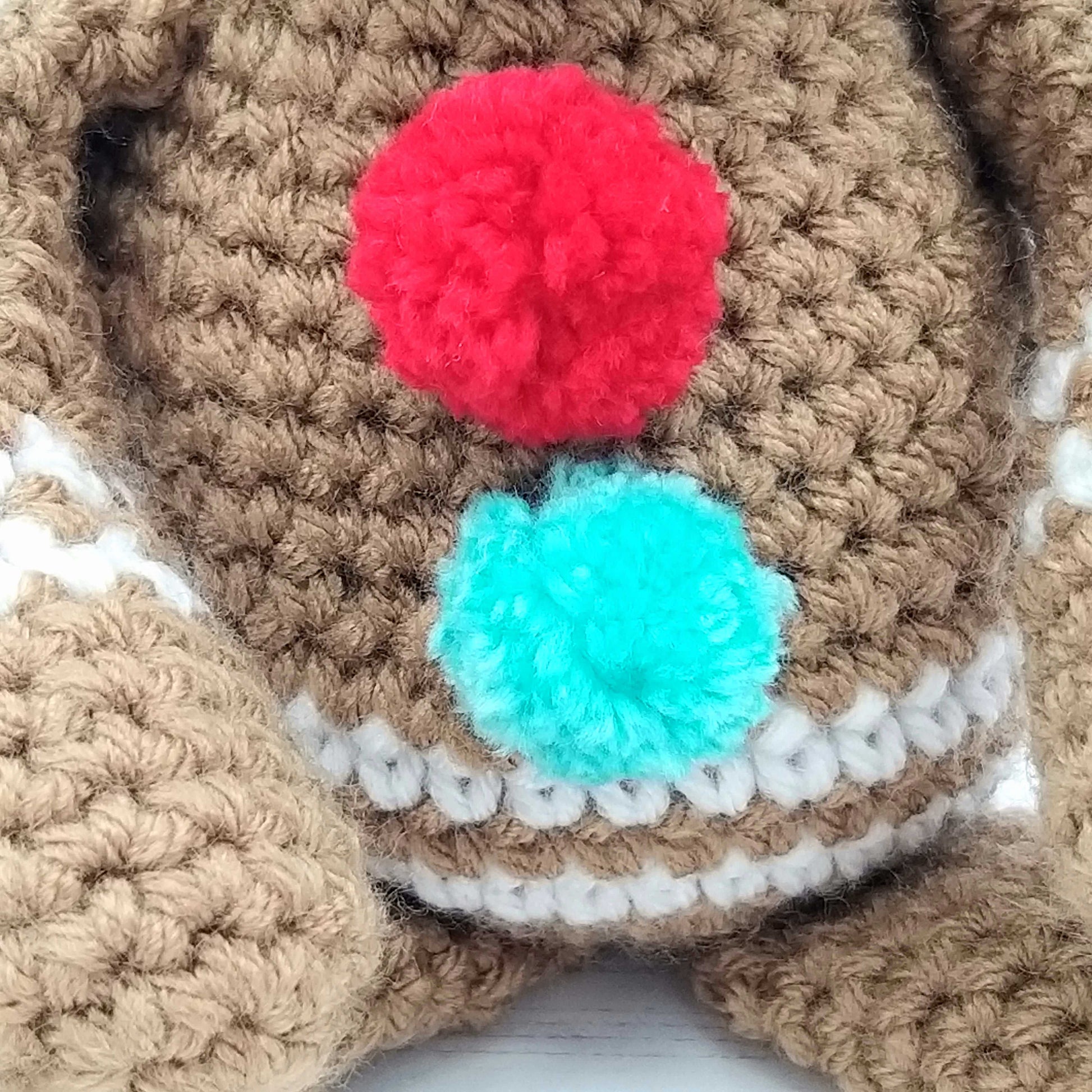Close up of crochet buttons on Gingerbread Man toy