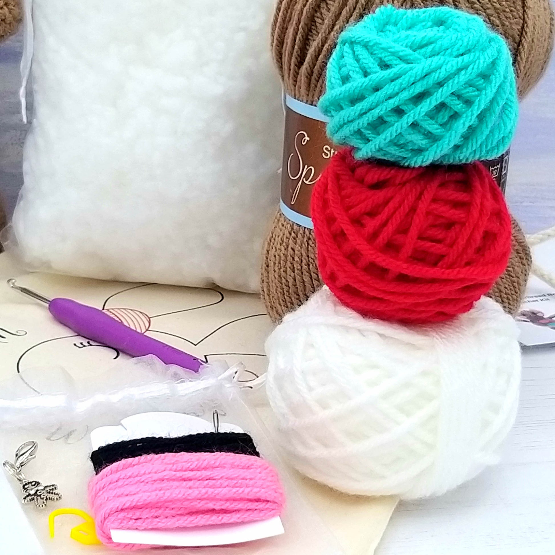 Balls of yarn used in kit - white, brown, red and blue