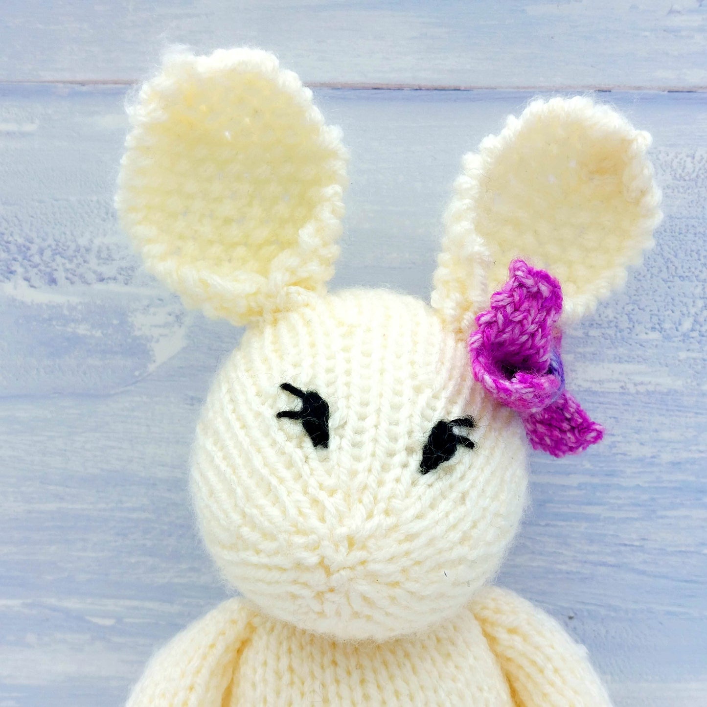 Close of head of knitted rabbit toy