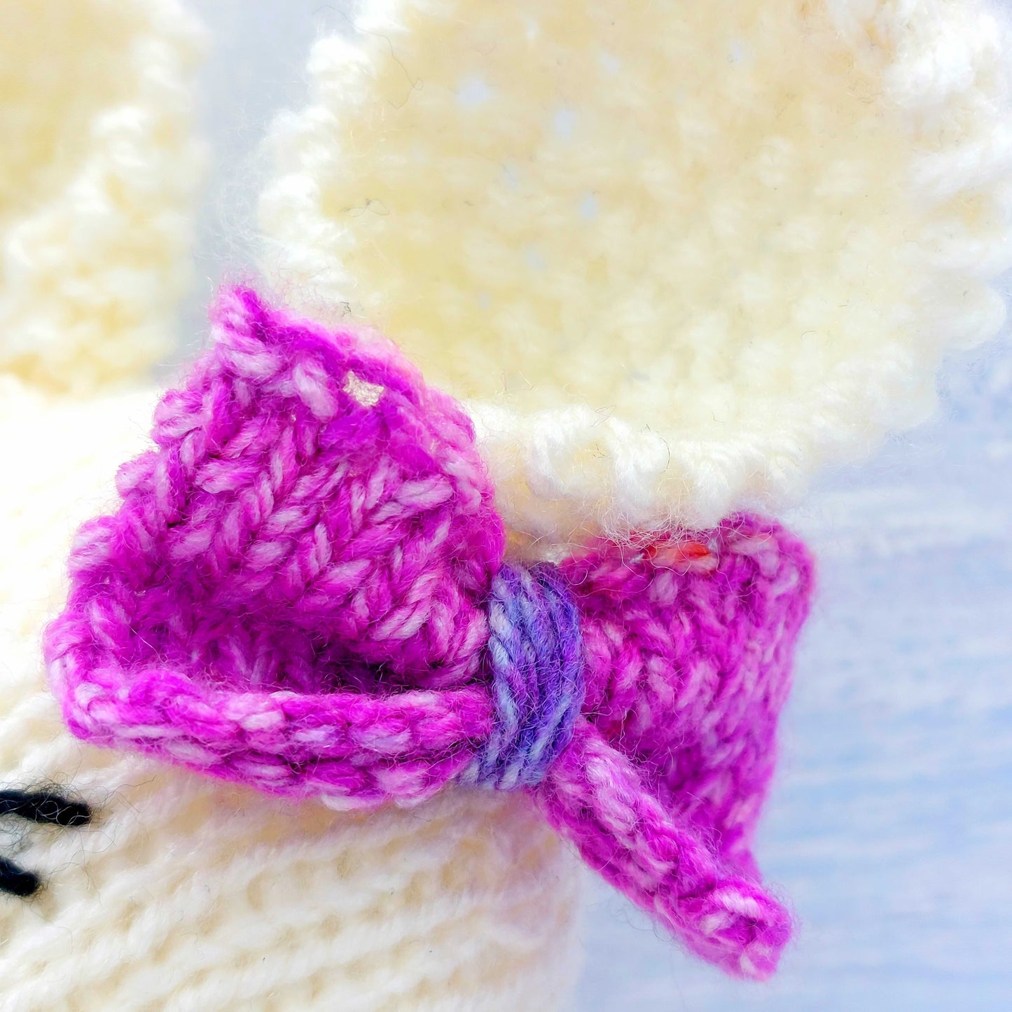 close up of knitted bow on bunny rabbit