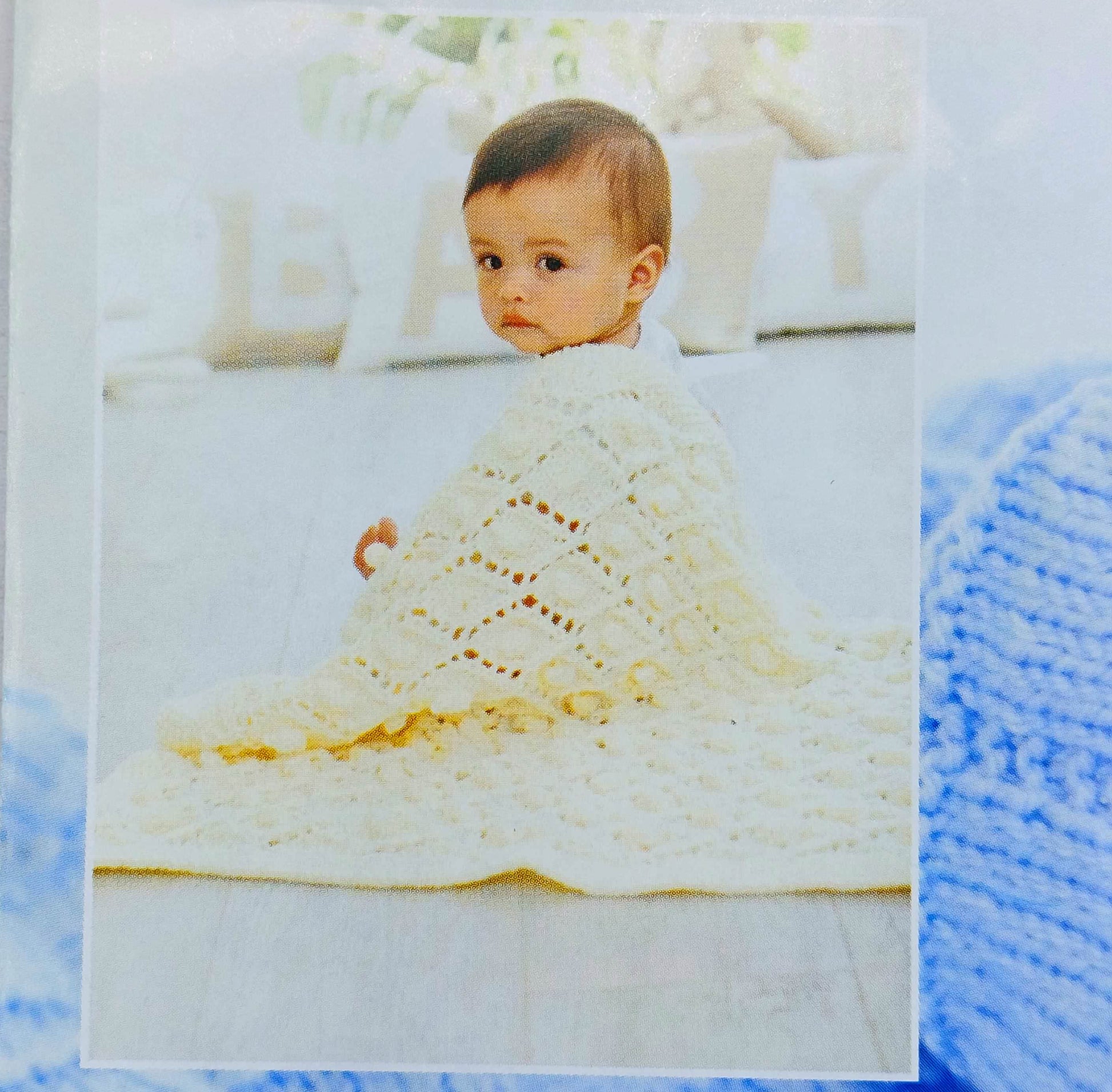 Baby with cream knitted blanket